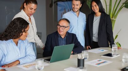 Diverse business team meeting with a consultant in a contemporary office to review ideas and solutions