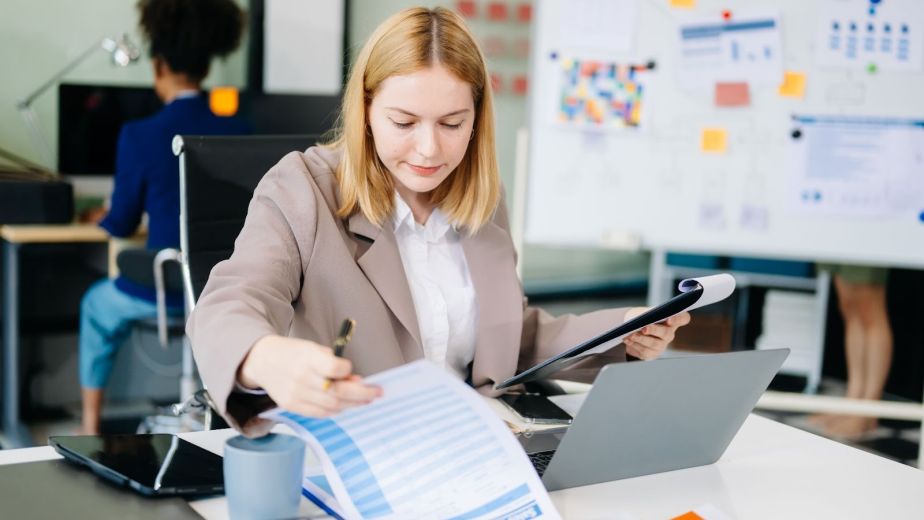 A business advisor examines financial documents.