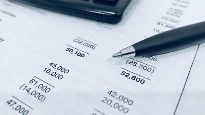 Close-up of a calculator and a financial balance sheet for accounting service analysis