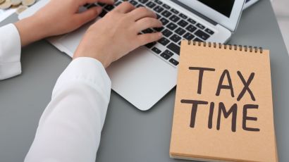 Professional bookkeeper updates the entries on a laptop to maintain organized financial data during tax time