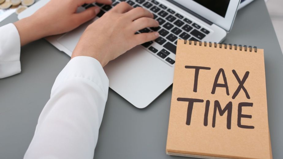 Professional bookkeeper updates the entries on a laptop to maintain organized financial data during tax time